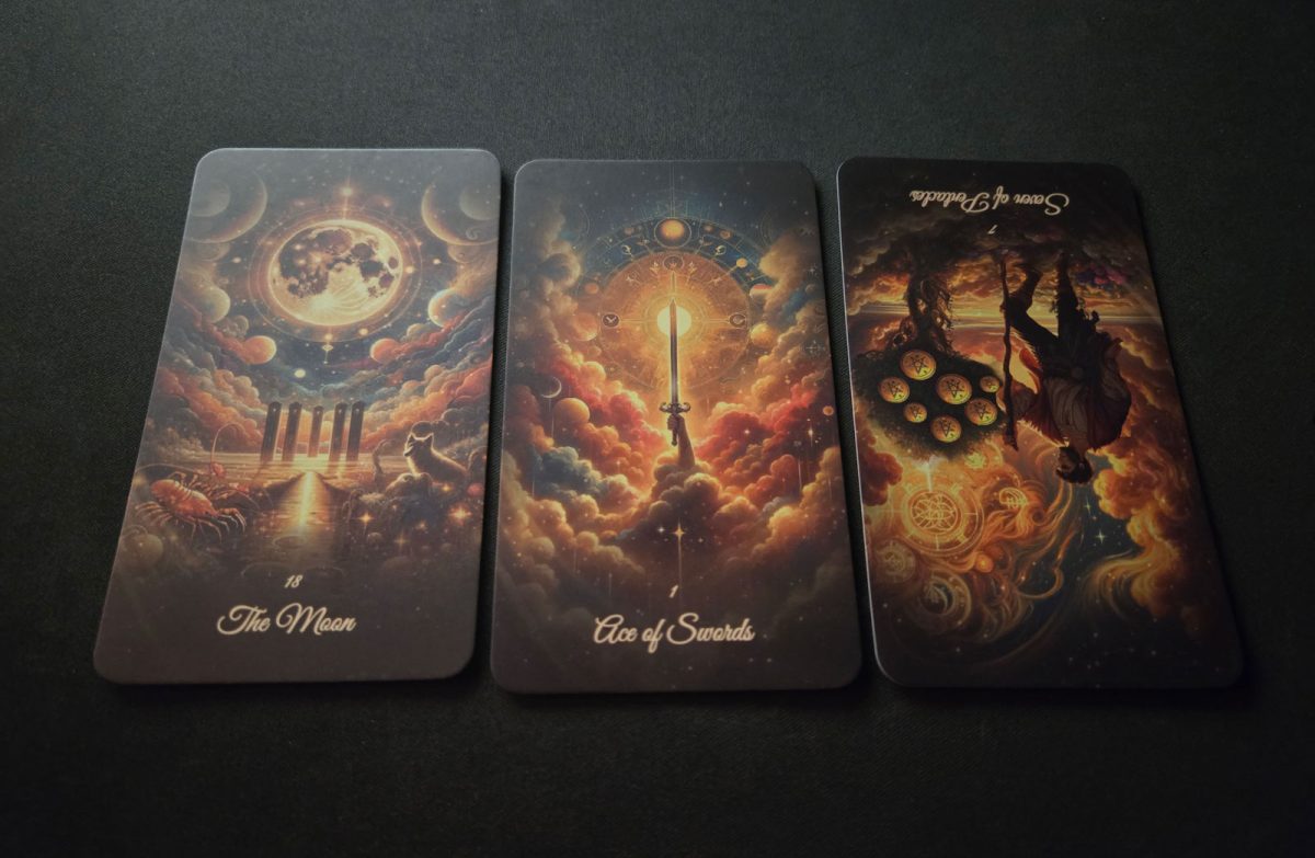 May 2025 tarot productivity hacks cards: The Moon, Ace of Swords, and reversed Seven of Pentacles.